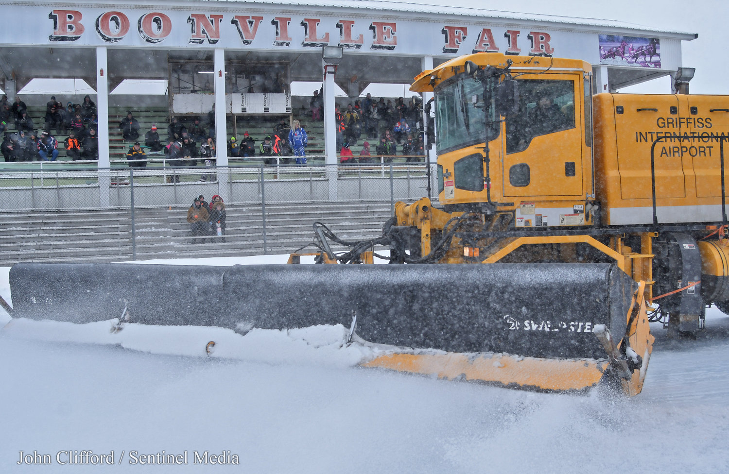 A Griffiss International Airport brush machine helped groom the track in between sets of heats and finals during the Snow Festival snowmobile racing Saturday and Sunday.