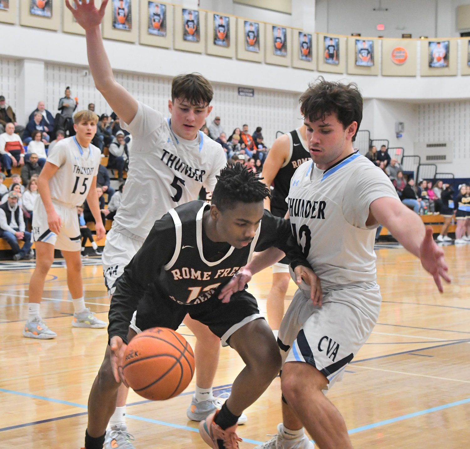 Rome Free Academy's Deandre Neal gets trapped by Central Valley Academy's Ray Watson, right, and TJ Luke on Friday night in a TVL game at CVA. The Thunder remained unbeaten with a 76-64 win.