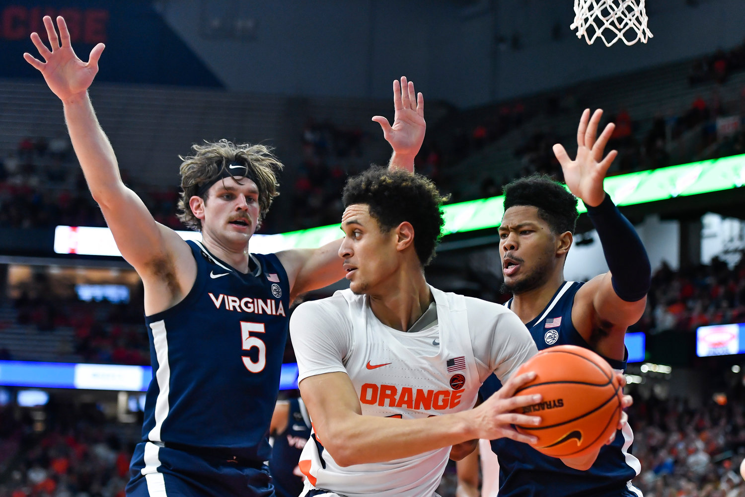 Syracuse center Jesse Edwards, center, is defended by Virginia forwards Ben Vander Plas, left, and Jayden Gardner during the first half of Monday night's game in Syracuse. The Orange lost 67-62.