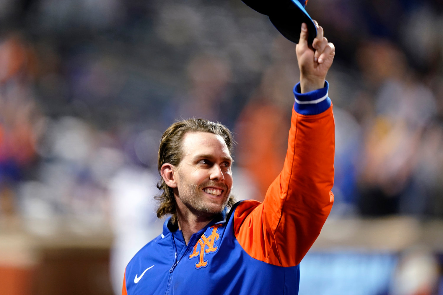 New York Mets' Jeff McNeil gestures to fans during the fourth inning of the team's baseball game against the Washington Nationals on Oct. 5, 2022, in New York. McNeil and the Mets finalized a $50 million, four-year contract Tuesday, Jan. 31, 2023 that avoided a salary arbitration hearing.