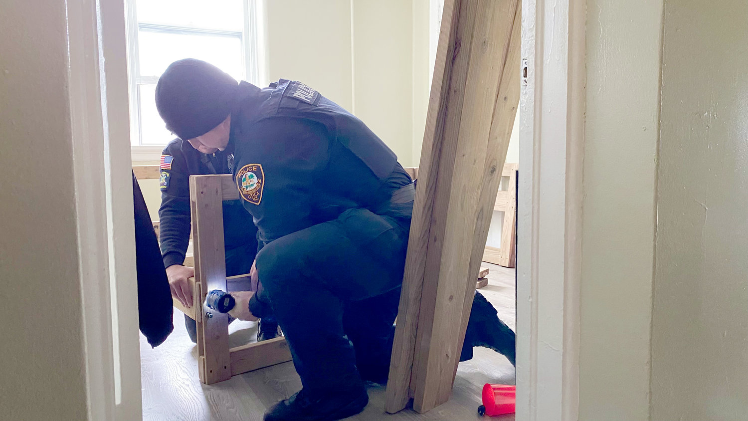 First responders with the Utica Police Department and the Utica Fire Department assisted volunteers with the Utica chapter of Sleep in Heavenly Peace as they delivered and assembled three beds to a family in west Utica.