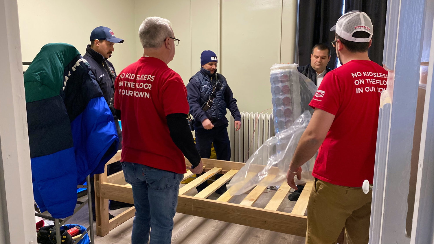 First responders with the Utica Police Department and the Utica Fire Department assisted volunteers with the Utica chapter of Sleep in Heavenly Peace as they delivered and assembled three beds to a family in west Utica.