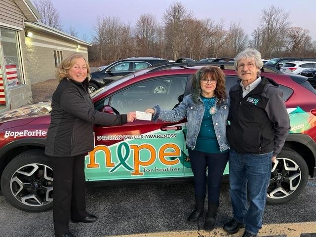 Mohican Model A Ford Club member Sharon Voninski, left, and Frieda Weeks, CEO of Hope for Heather gather for a recent check donation ceremony. The club made a trio of donations to local organizations to help others in need.