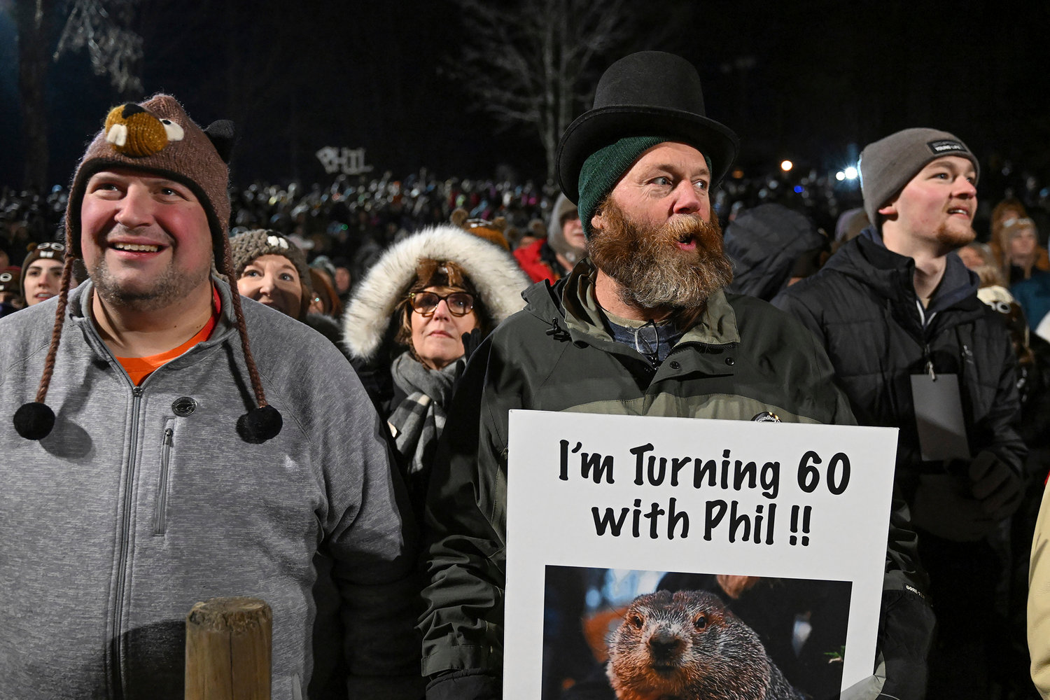 Rory Szwed, left, and Kent Rowan watch the festivities while waiting for Punxsutawney Phil, the weather prognosticating groundhog, to come out and make his prediction during the the 137th celebration of Groundhog Day on Gobbler's Knob in Punxsutawney, Pa., Thursday, Feb. 2, 2023.