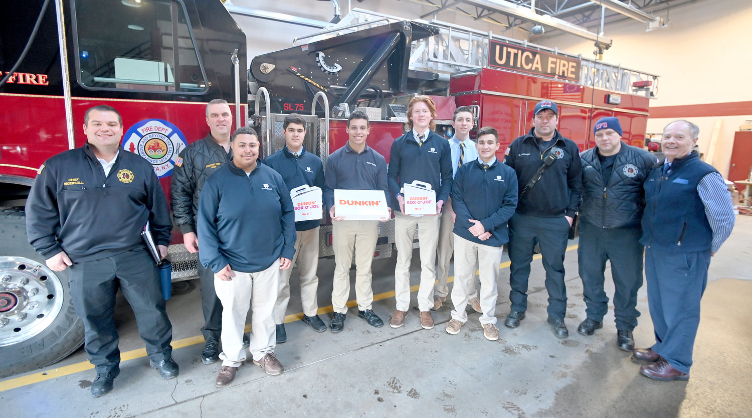 Doughnuts were donated to the Utica Fire Department Wednesday, Feb. 1 by Notre Dame Junior/Senior High School students. From left are Utica Chief Scott Ingersoll, Assistant Chief James Noon, students Marquis Reeves, Sean Noon, Isaiah Sexton, Jake Engelhart, Tim Carville and Louis Robertelli, Utica Firefighter Garrett Tomanio, Lt. Joe Topa and Notre Dame Campus Minister Bob McQueen.
