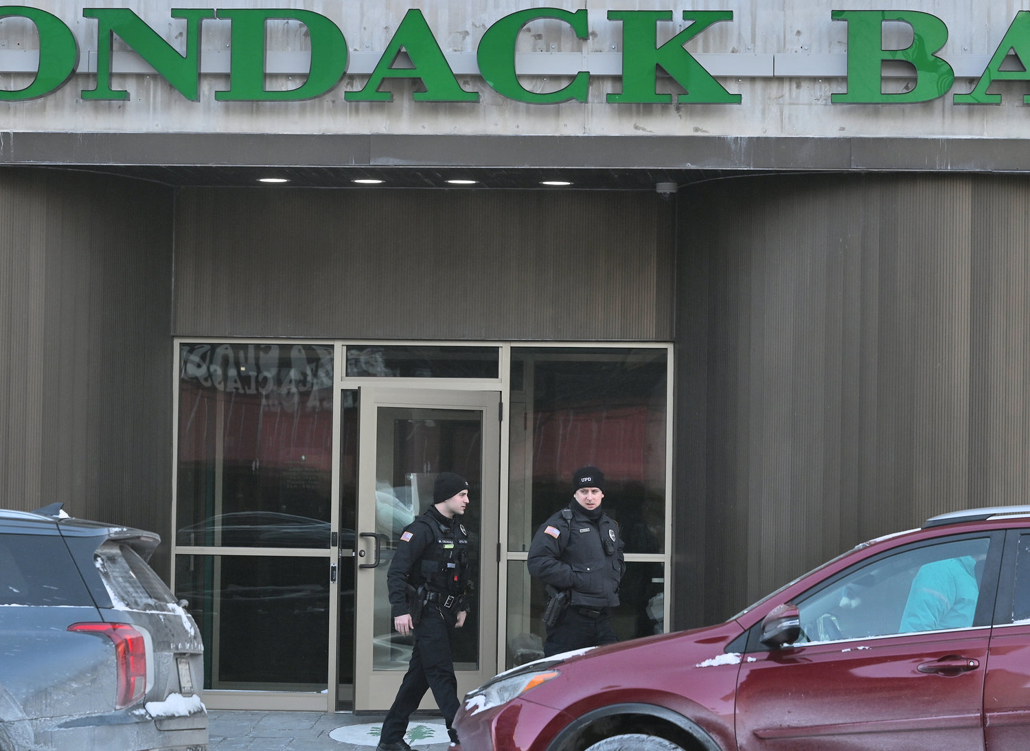 Utica Police walk out of Adirondack Bank at 185 Genesee St. Utica Friday morning.