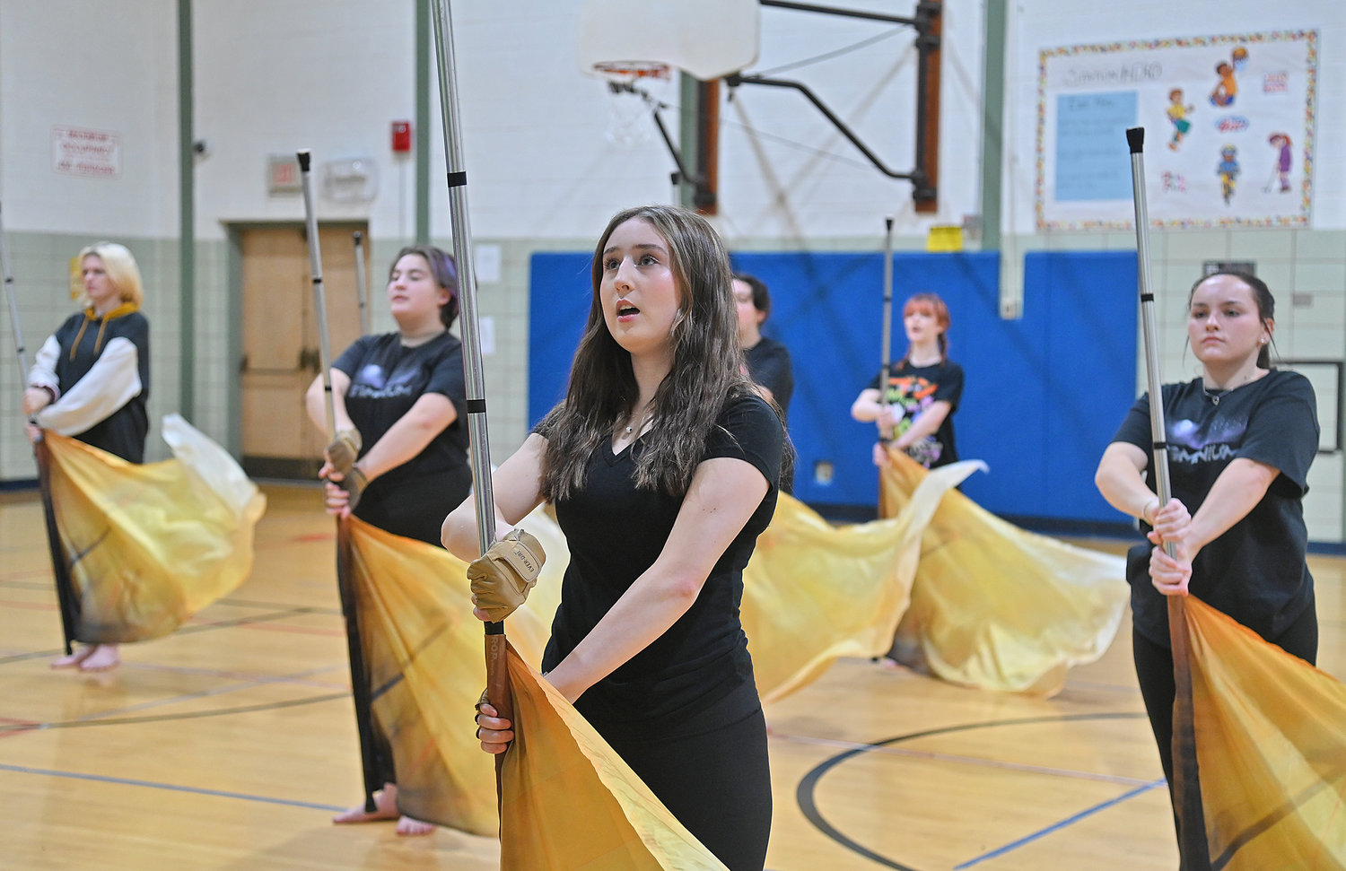 New Hartford Varsity Winter Guard members go through their rehearsals exercises at the Myles Elementary School gym.