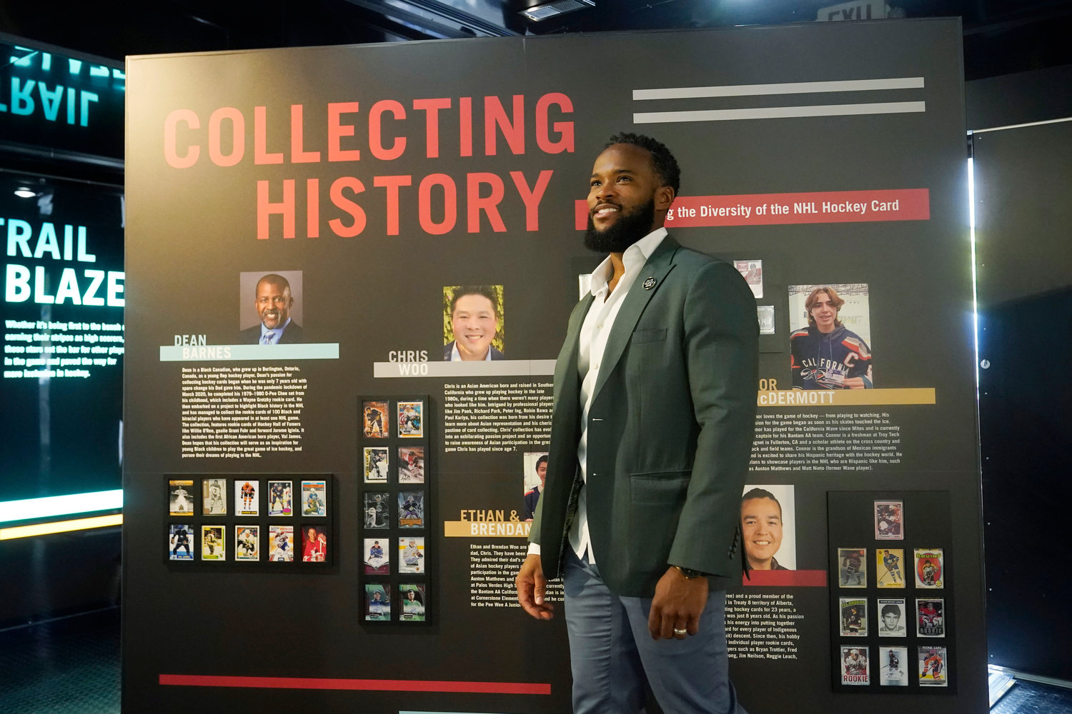 Jeff Scott, NHL vice president of Community Development and Growth, walks by one of the exhibits inside the United Hockey Mobile Museum, Thursday, Feb. 2, 2023, in Fort Lauderdale, Fla. The museum highlights the hockey careers of underrepresented communities and women.