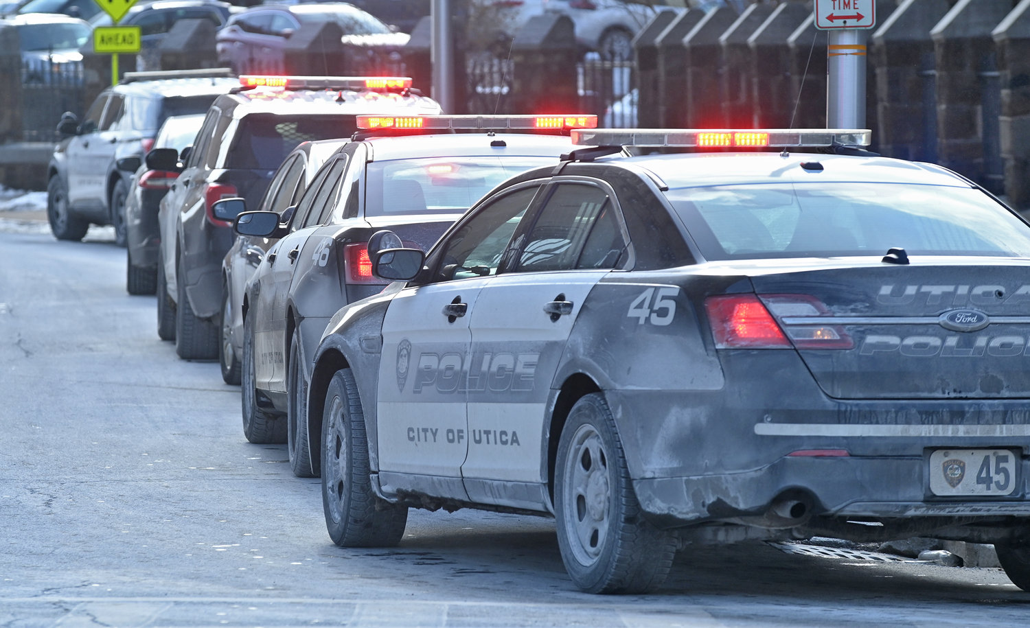 Utica Police cars lined up on Elizabeth Street next to Adirondack Bank that was robbed Friday morning on Genesee Street in Utica.