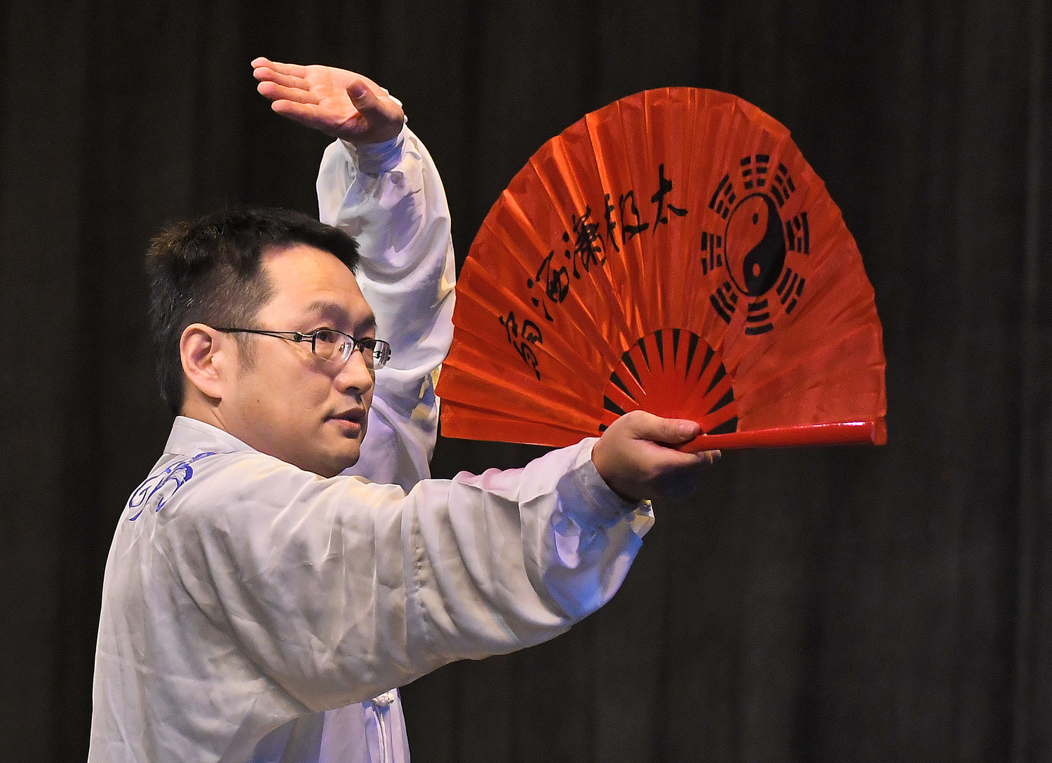 Huiyang Li, from the Confucius Institute at Alfred University, performs a Tai Chi Fan routine Friday, Feb. 3, in the Clinton Middle School auditorium.