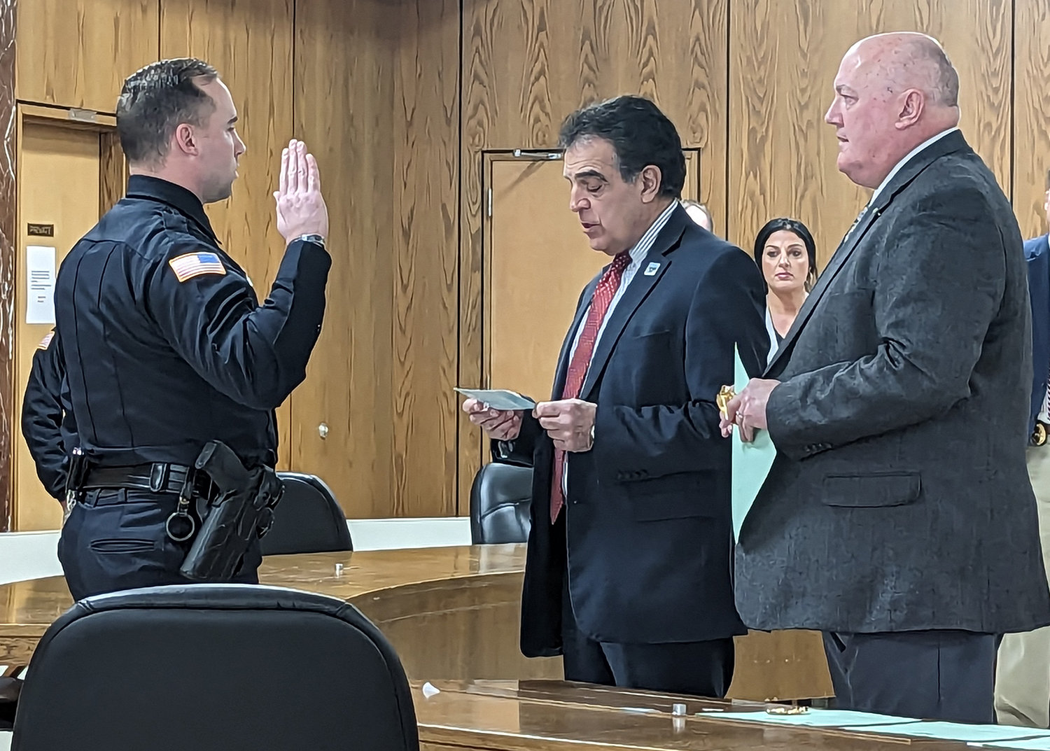 Joshua Austin takes the oath of office in his promotion to sergeant with the Utica Police Department. Utica Mayor Robert Palmieri delivered with oath, alongside Chief mark Williams, at Utica City Hall on Friday.