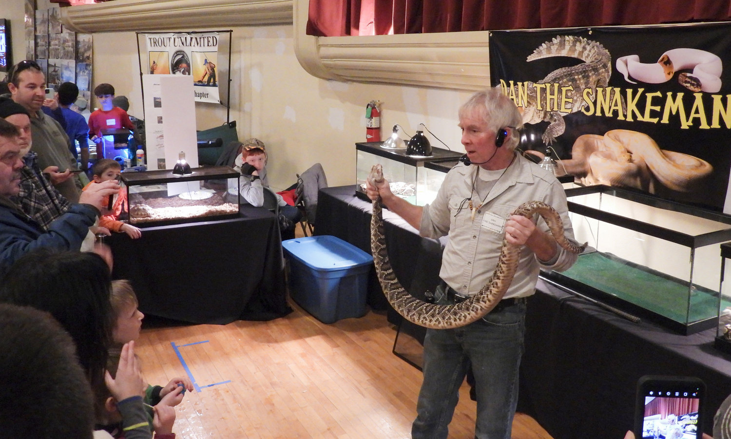 Dan Chase a.k.a Dan the Snakeman shows a crowd of participants a rattlesnake up close and personal at the CNY Sportsman Show on Saturday, Feb. 4.