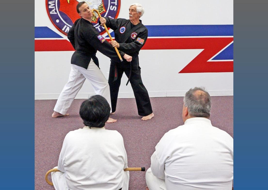 Grandmaster Clifford Crandall Jr., right, demonstrates cane self-defense with Eric Stalloch in class.
