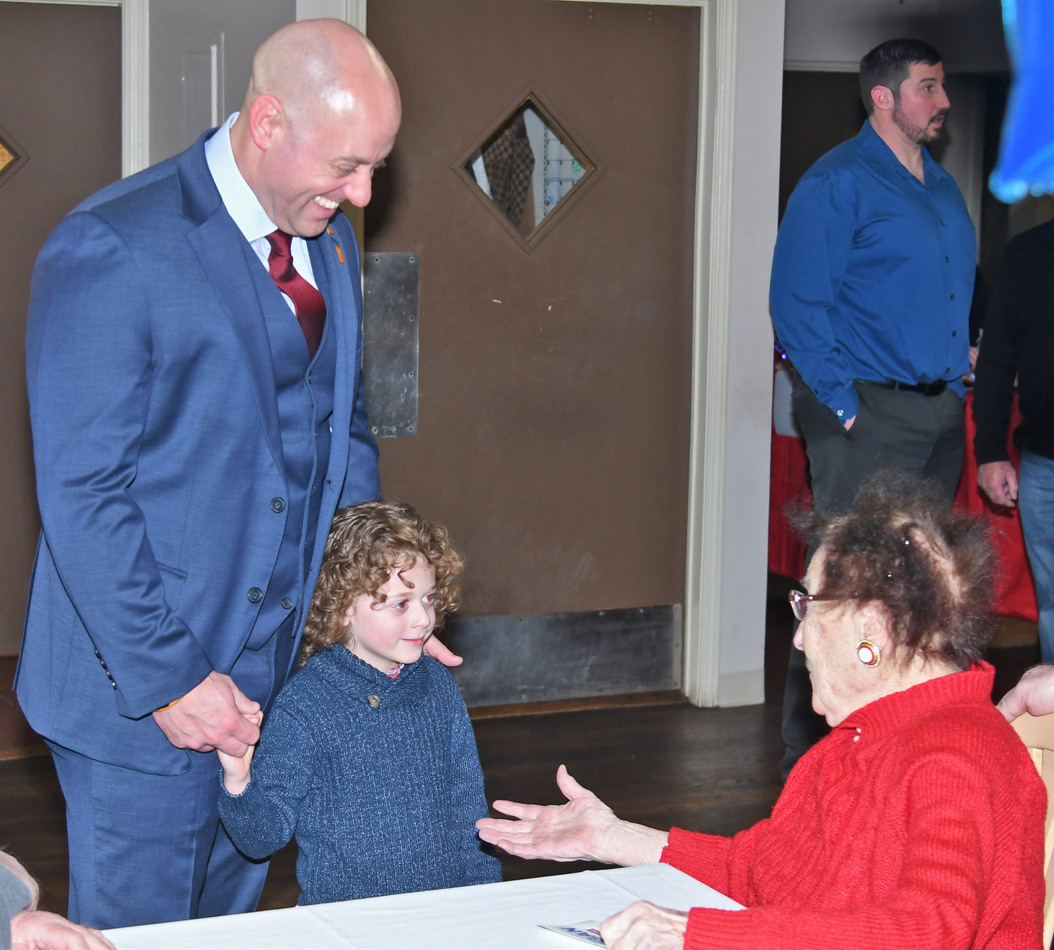 Rome mayoral candidate Jeffrey M. Lanigan and his son, Connor, age 5, greet supporter Pauline Cianfrocco at the Franklin Hotel on South James Street in Rome Tuesday evening.