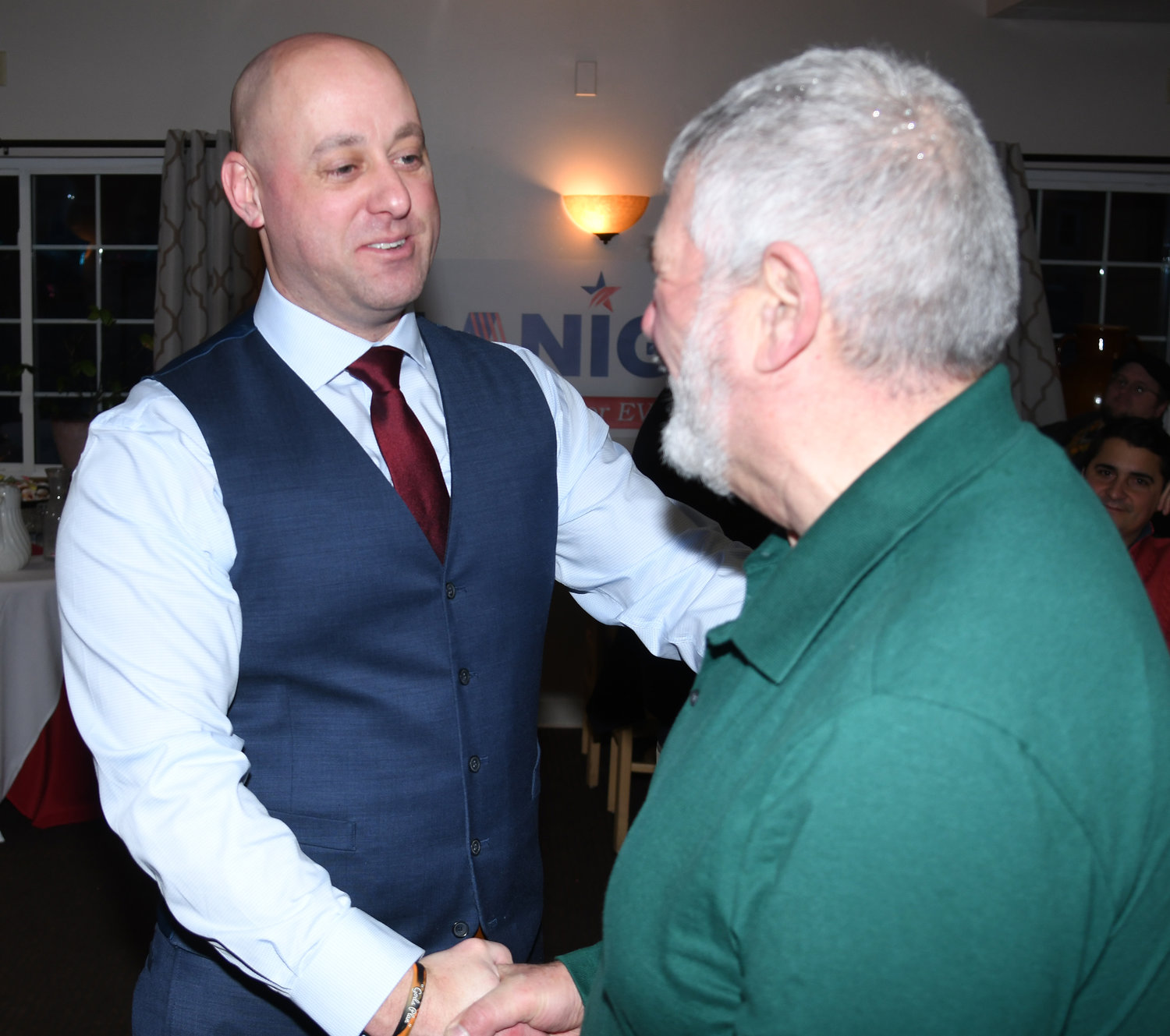 Rome mayoral candidate Jeffrey M. Lanigan shakes the hand of supporter Paul Nasci before the start of his announcement at the Franklin Hotel in Rome Tuesday evening.