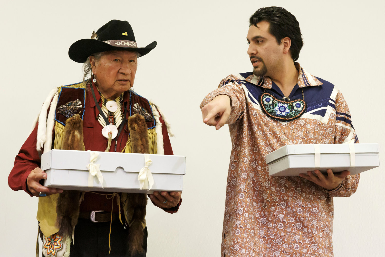  Two representatives of Haudenosaunee Confederation Clayton Logan, left, of the Seneca Nation, and Brennen Ferguson, of the Tuscarora Nation, hold boxes containing sacred objects during the ceremony of restitution of sacred object to the Haudenosaunee Confederation, at the Museum of Ethnography of Geneva in Switzerland on Tuesday, Feb. 7. 

The MEG has returned traditional sacred objects, a mask and a rattle, to the Haudenosaunee after 200 years in Switzerland. In addition to the Seneca and Tuscarora nations, the Haudenosaunee, “the people who are building the longhouse,” are comprised of the Mohawk, Oneida, Onondaga, and Cayuga Indian Nations.