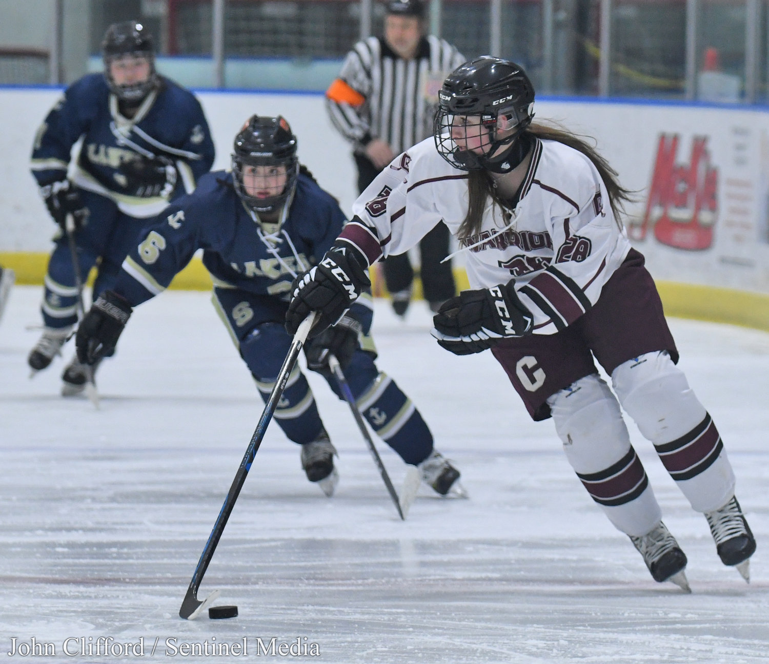 The Clinton Warriors in action against the Skaneateles Lakers in the Section III girls ice hockey championship Wednesday night in Nedrow. Clinton beat Skaneateles 1-0 in overtime. Clinton #28 brings the puck up ice.