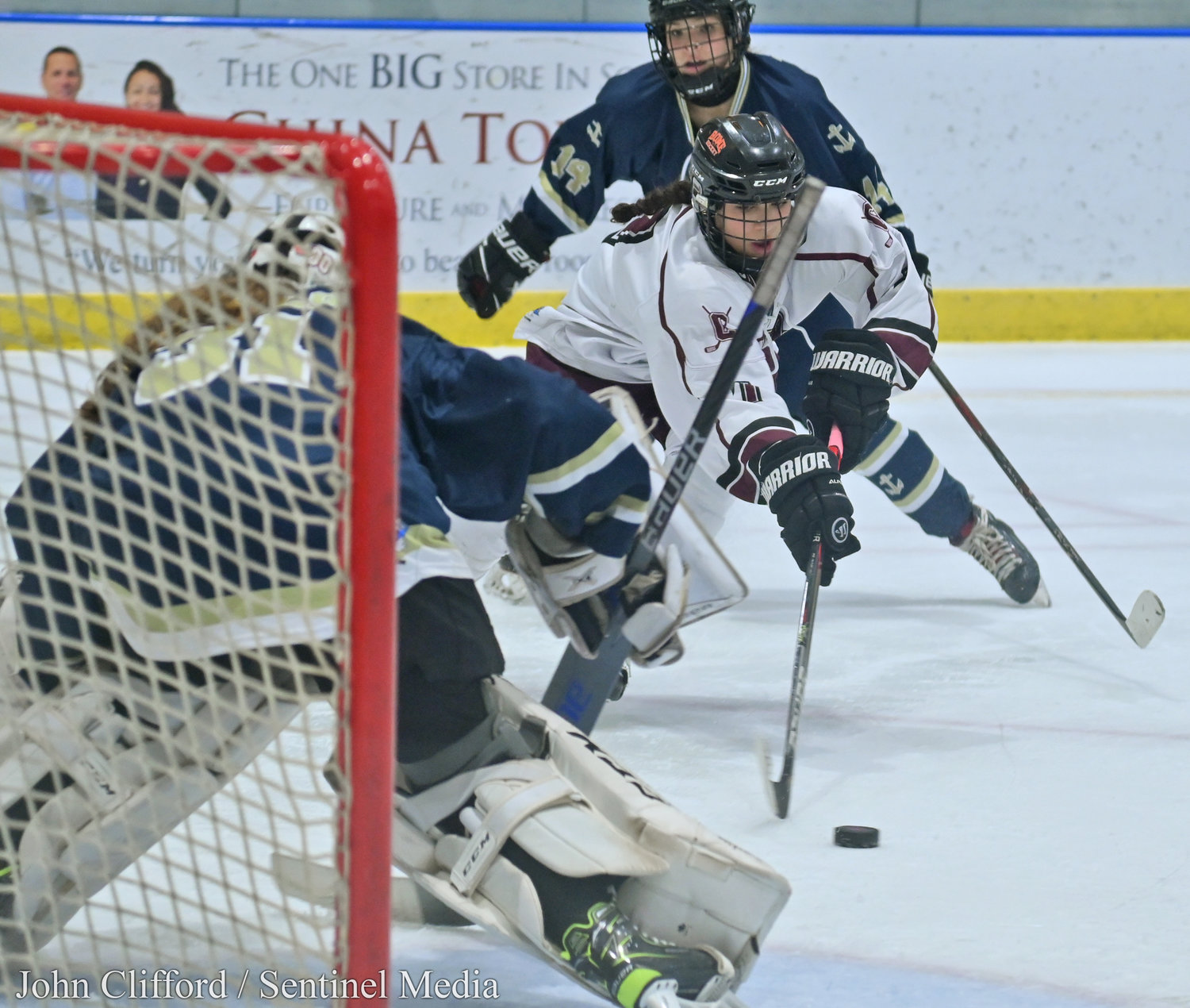 The Clinton Warriors in action against the Skaneateles Lakers in the Section III girls ice hockey championship Wednesday night in Nedrow. Clinton beat Skaneateles 1-0 in overtime. Clinton #7 swooping with Lakers goalie #31.
