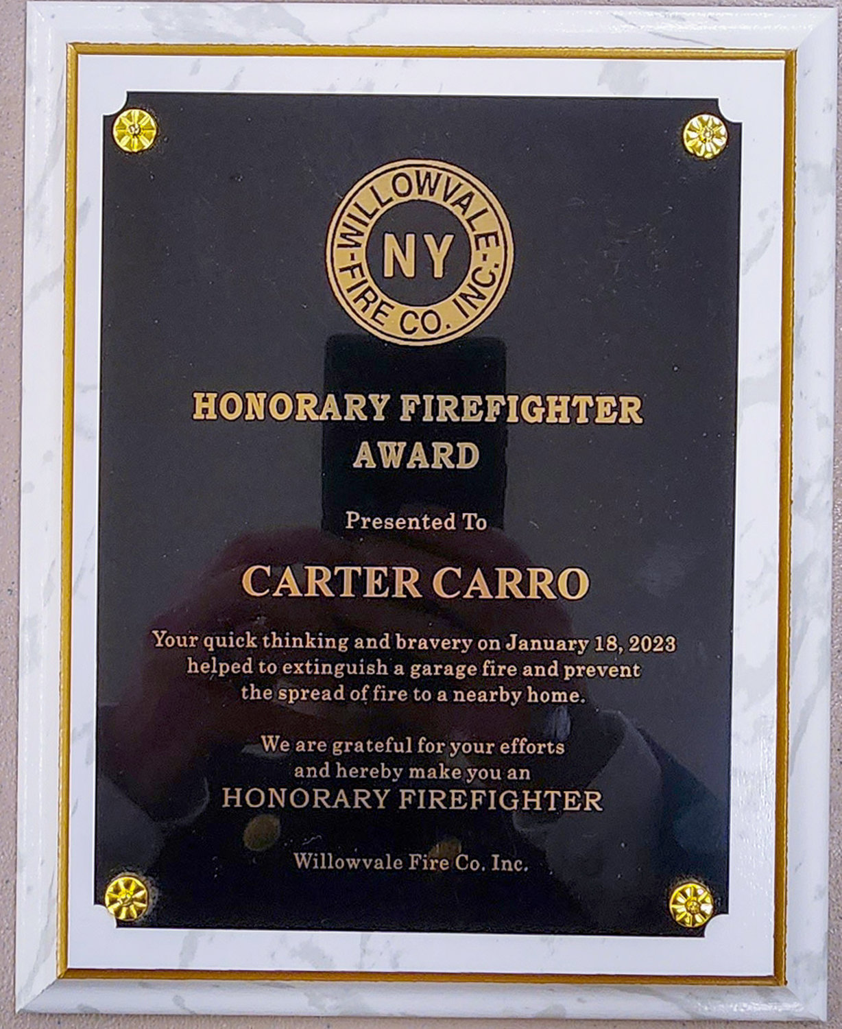 Carter Carro's honorary firefighter award.