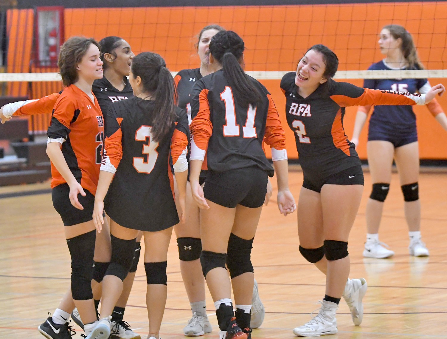 The Rome Free Academy girls volleyball team celebrates winning the first set in the Class A quarterfinal match against East Syracuse-Minoa on Friday at Strough Middle School in Rome. RFA won in four sets to advance to the semifinals.
