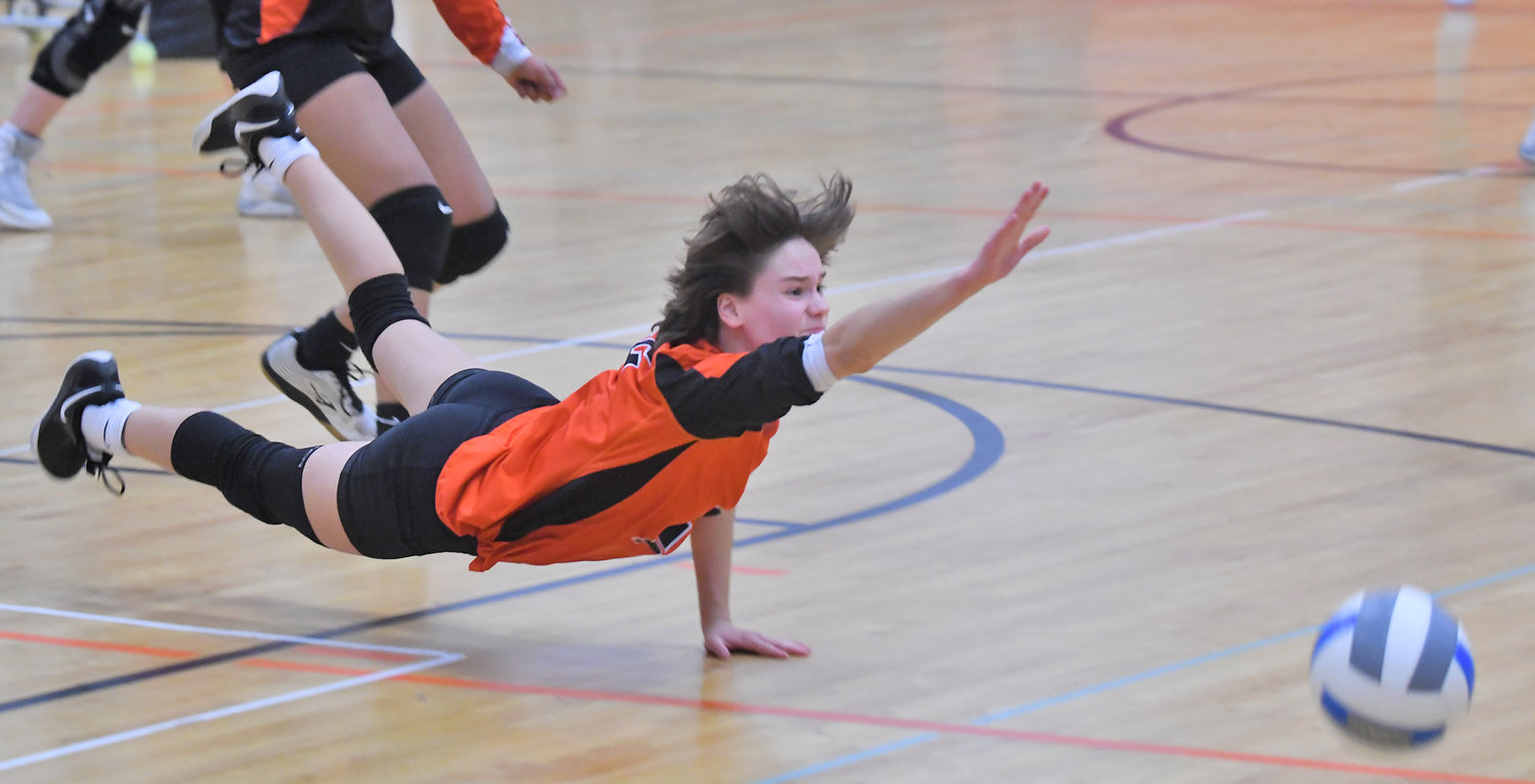 Rome Free Academy digger Shannen Calandra dives to get a hand on the ball during the Class A quarterfinal match against East Syracuse Minoa at Strough Middle School in Rome Friday night. Calandra had 13 digs in the Black Knights' four-set win.