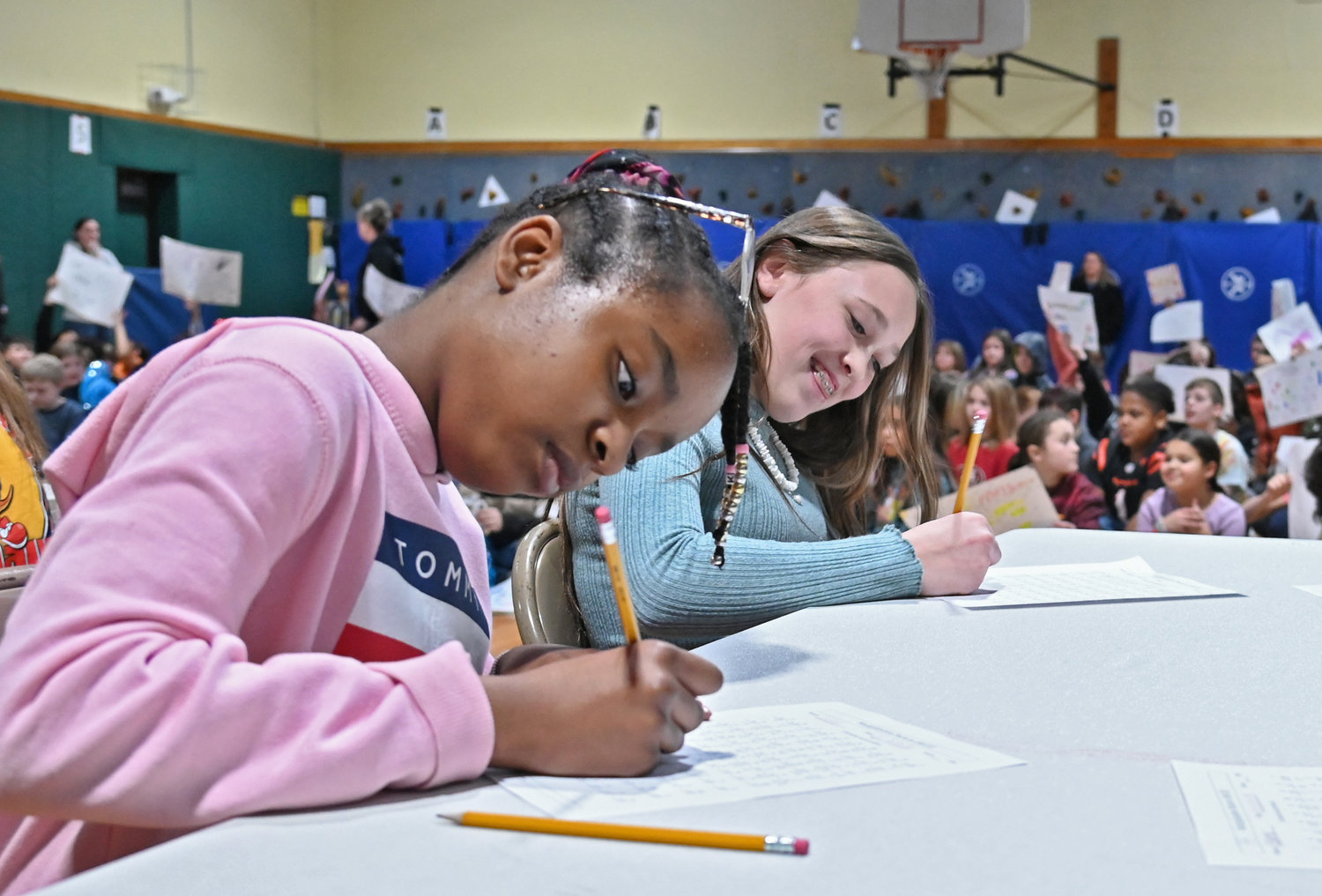 Kate Chapoteau and Rylee Anderson work on their math problems in the five-minute deadline to complete them Friday, Feb. 10 during the Math Fact Super Bowl STEM finals at Gansevoort Elementary School in Rome.