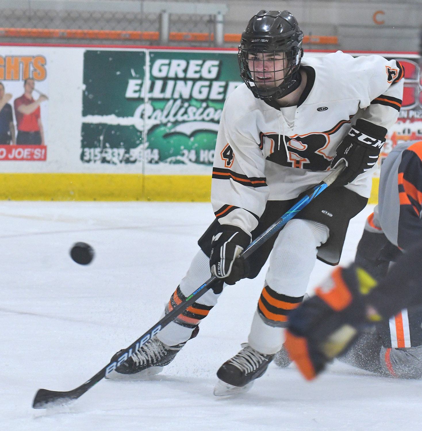Rome Free Academy senior defenseman Tyler Wilson chases down the puck in front of the Liverpool goal at home on Dec. 13. Wilson was named a Section III Division 1 second team all-star.