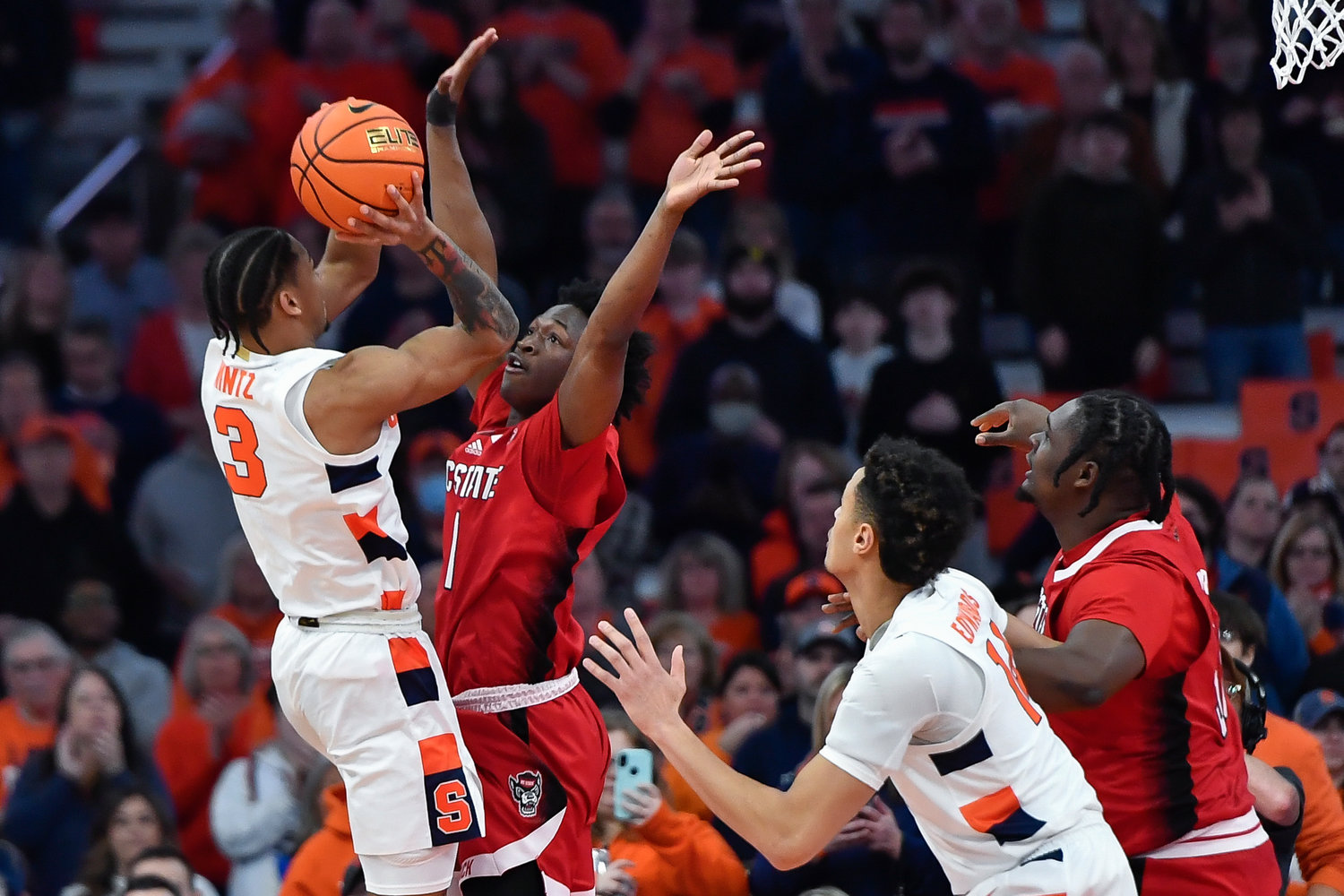 Syracuse guard Judah Mintz, left, shoots while defended by North Carolina State guard Jarkel Joiner during the first half of Tuesday night's game at the JMA Wireless Dome in Syracuse. Mintz scored 20 points as the Orange won 75-72.