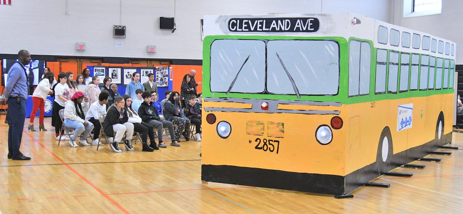 A class listens to the history of Rosa Parks Tuesday, Feb. 14 at Strough Middle School in Rome.  They sit near a recreation of the bus where Parks refused to vacate her seat for a white passenger Dec. 1, 1955 in Montgomery, Alabama.