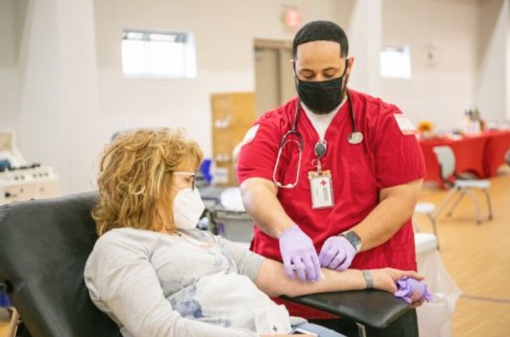 A donor rolls up her sleeves to donate blood at an American Red Cross blood donation event in this Red Cross file photo. The local chapter of the organization has issued a call for donations, including a list of upcoming blood drive events.