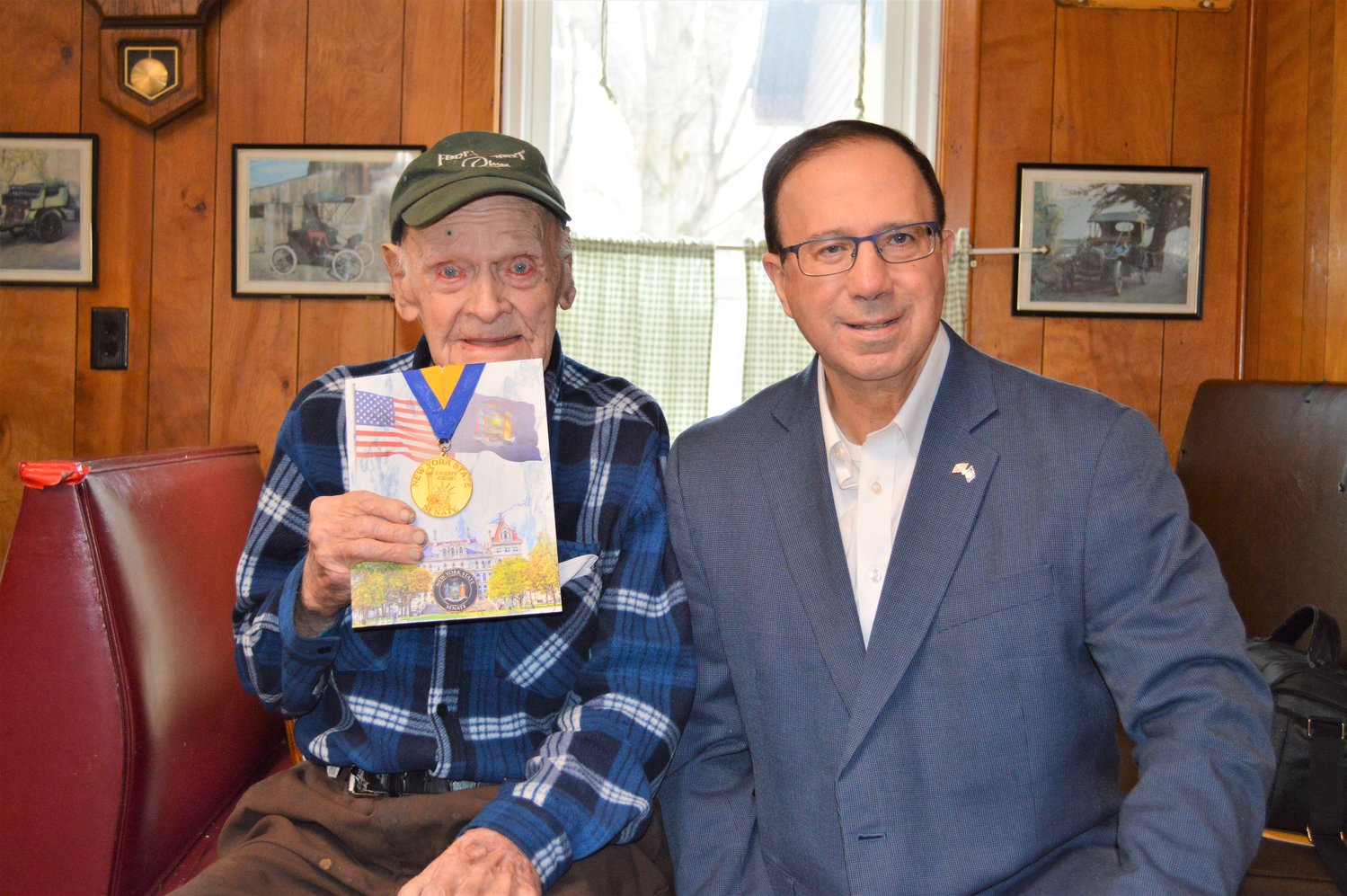 Terrence “Terry” Larkin, left, a World War II veteran who lives in Forestport, receives a New York State Senate Liberty Medal from Sen. Joseph A. Griffo, R-53, Rome, on Thursday at the Forestport diner.