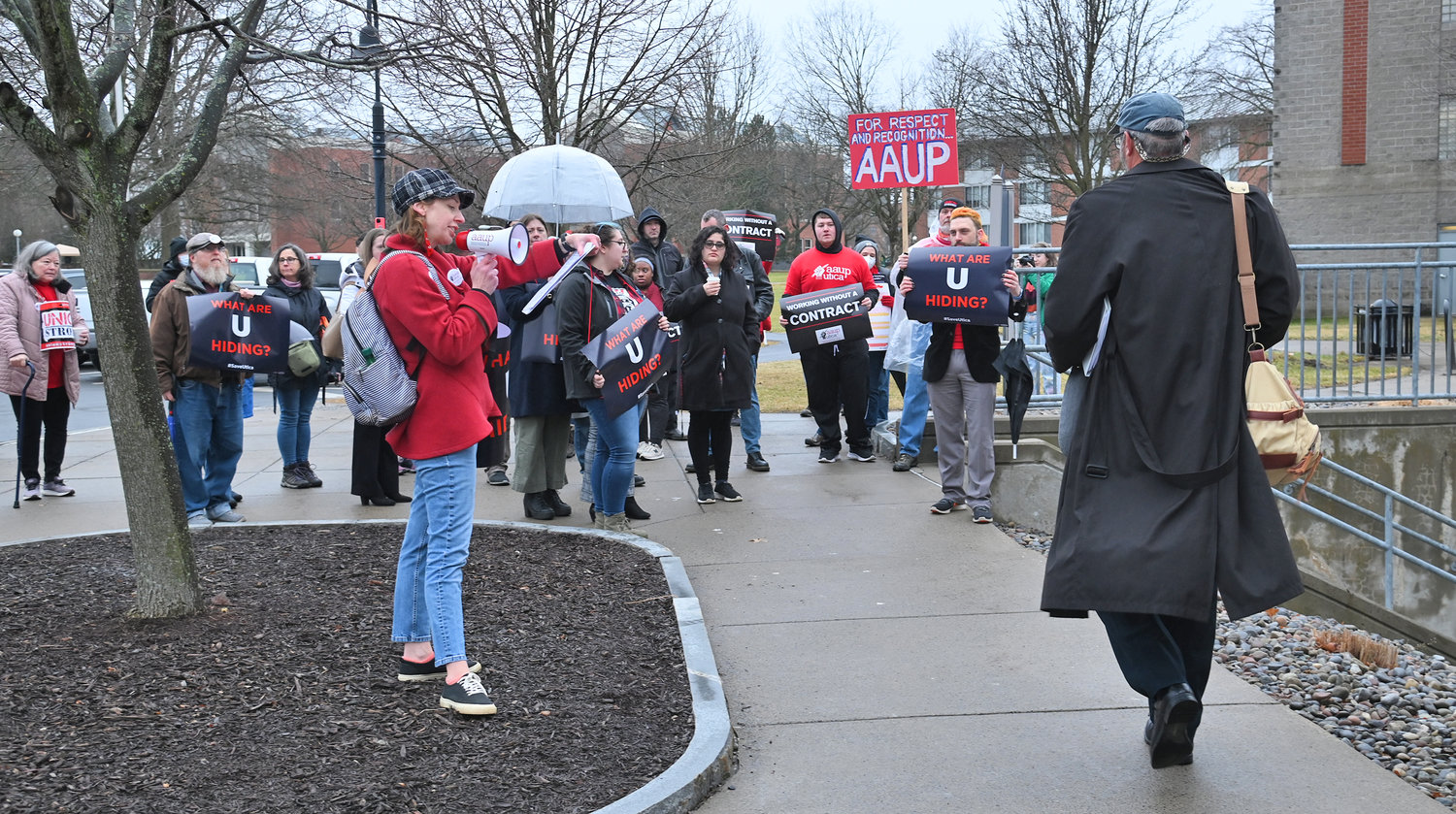 Associate Professor of Philosophy and AAUP union President Leonore Fleming barks out facts as a board member walks to the board meeting room Friday, Feb. 17 at Utica University.