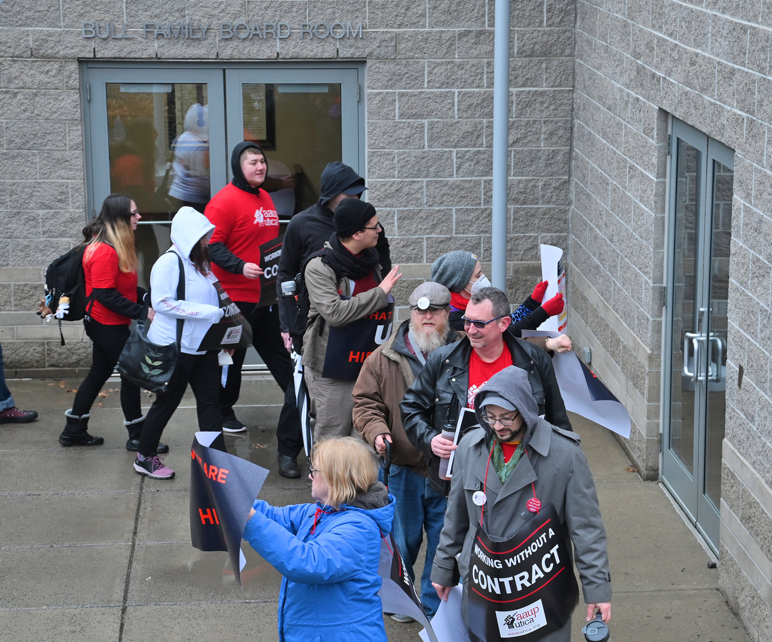 Protesters parade by the Bull Family Board Room Friday, Feb 17, 2023 at Utica University.