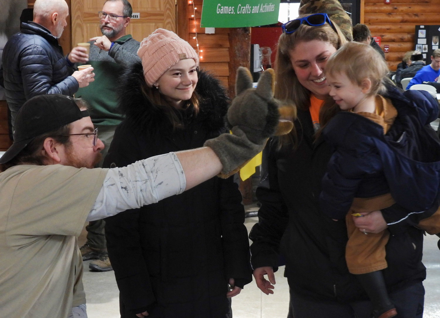 GSC Environmental Educator Jack Silky makes two-year-old Colton Mcardell laugh and smile while he's held by his mother Amanda and his Aunt Isabella Bonaventura looks on.