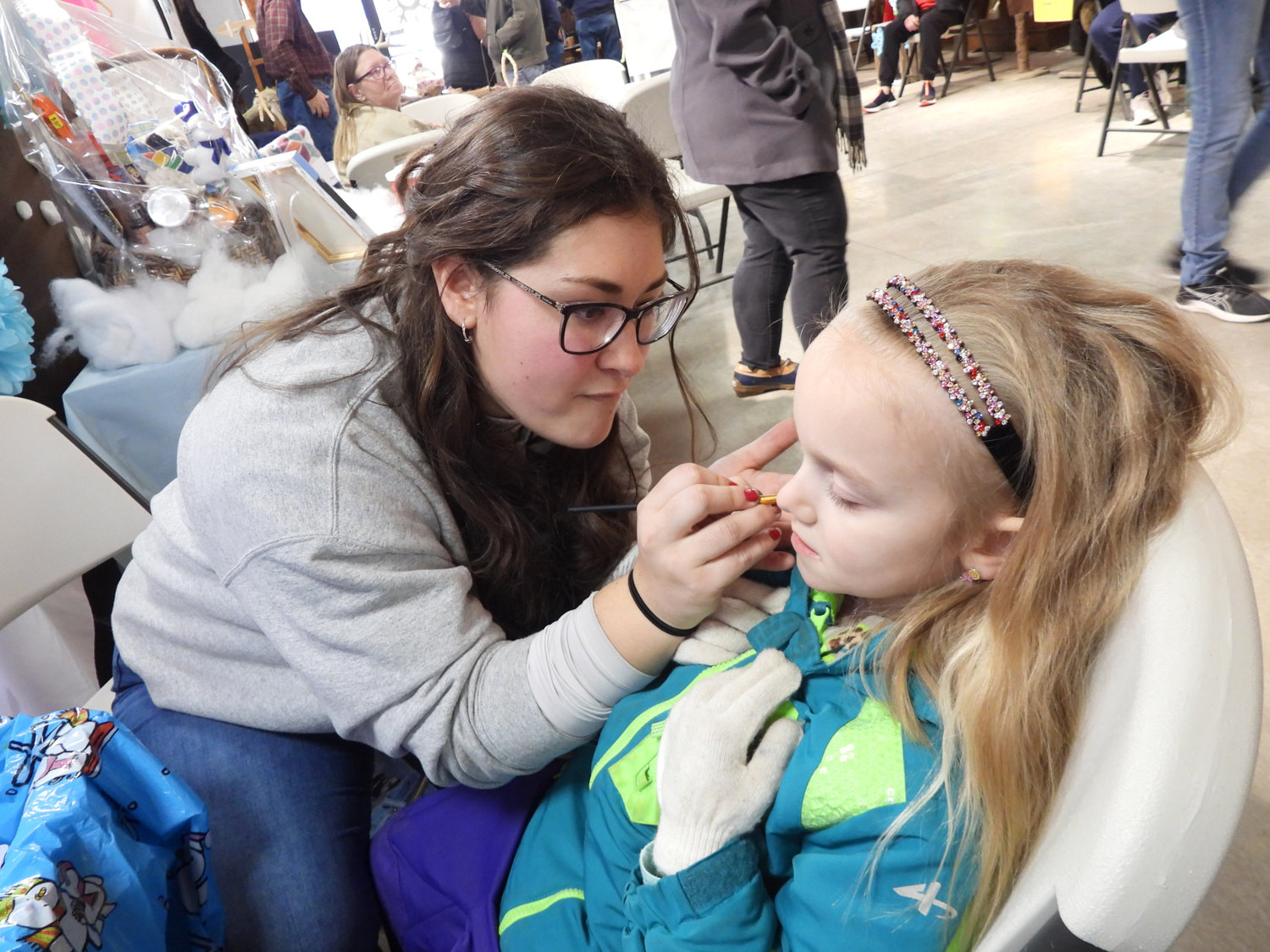 GSC Environmental Educator Gina Sciarra paints the face of a child at the Great Swamp Conservancy's Winter Hibernation Festival on Saturday, Feb, 18