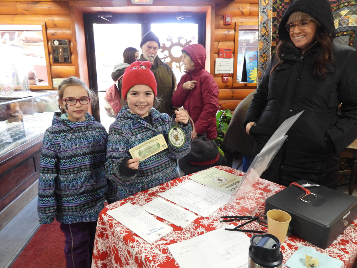 The Winter Hibernation Festival at the Great Swamp Conservancy saw people from all over, including Liverpool natives Grace Prentice, 8, center, and Charlotte Prentice, 5, right. Grace found the hidden medallion at the Great Swamp Conservancy and won herself $10, which she promptly donated right back to the Great Swamp Conservancy