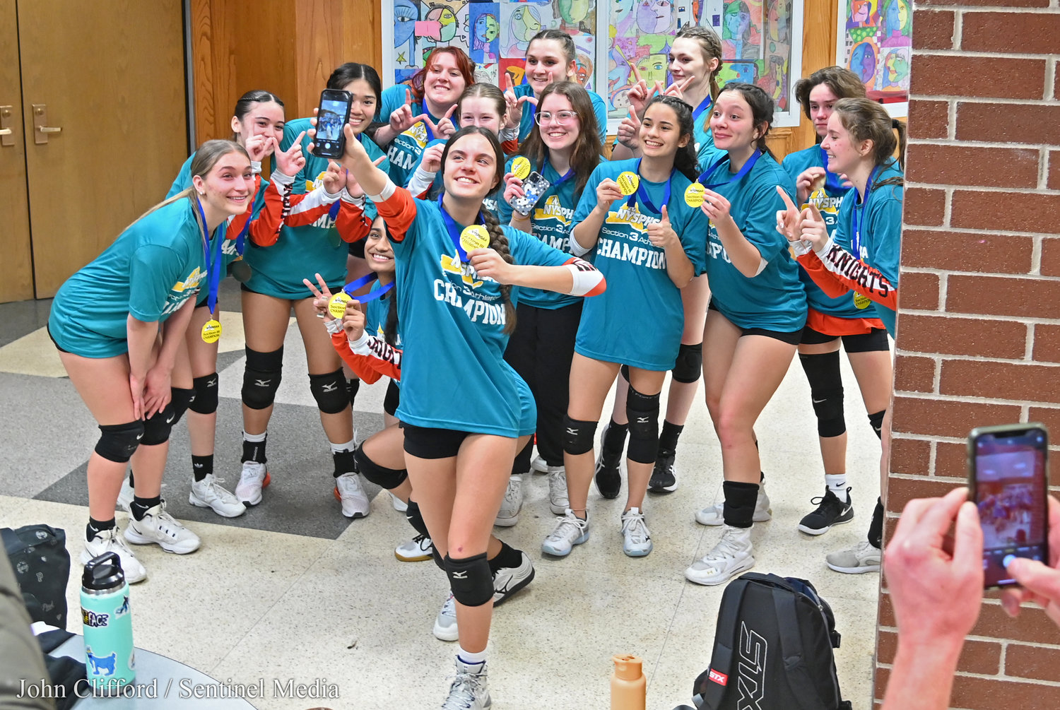Rome Free Academy Black Knights girls volleyball team taking a team selfie after they defeated Whitesboro in the Class A finals at Case Middle School in Watertown.