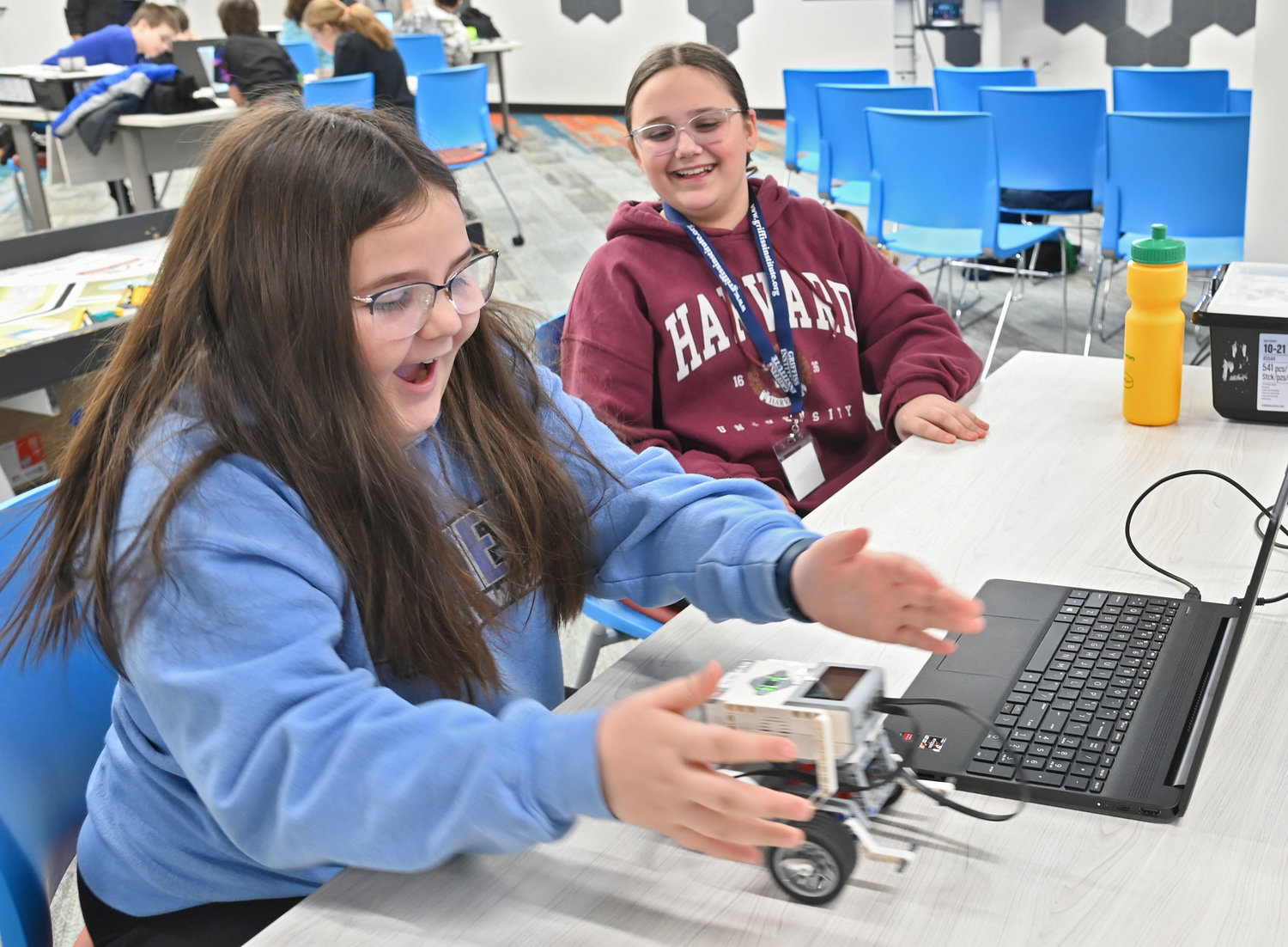 Victoria Parra, a fourth-grader at Bellamy Elementary School and Mackenzie Short, a fifth-grader at Gansevoort Elementary School, react to their robot successfully completing a command on Tuesday, Feb. 21, at Griffiss Institute’s Robotics Camp in Rome.