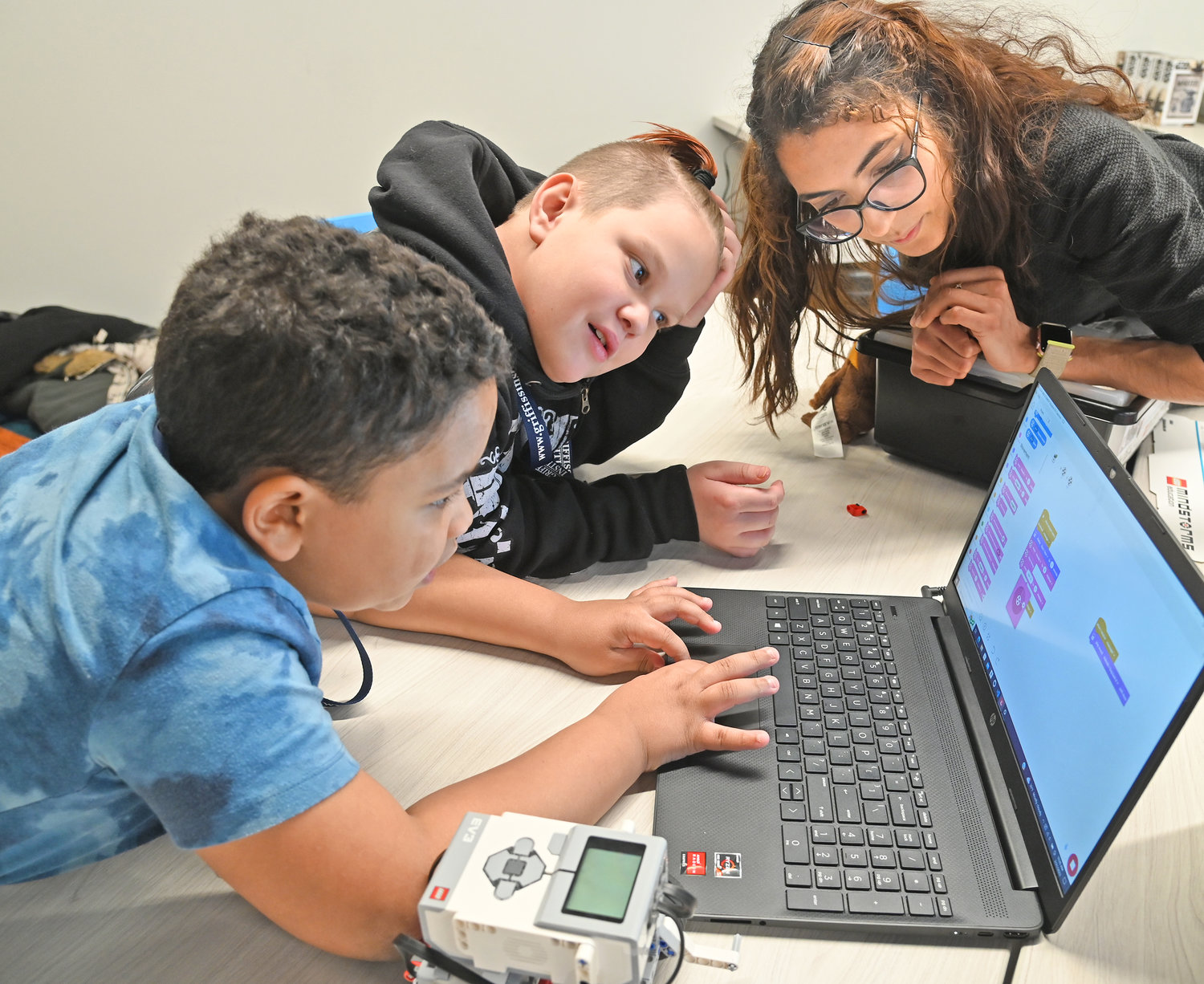 Mohawk Valley Community College Adjunct Professor Jessica Dubois. right, works with fourth graders Dante Johnson, left, and Wyatt Aldridge Tuesday, Feb. 21, at Griffiss Institute’s Robotics Camp in Rome.