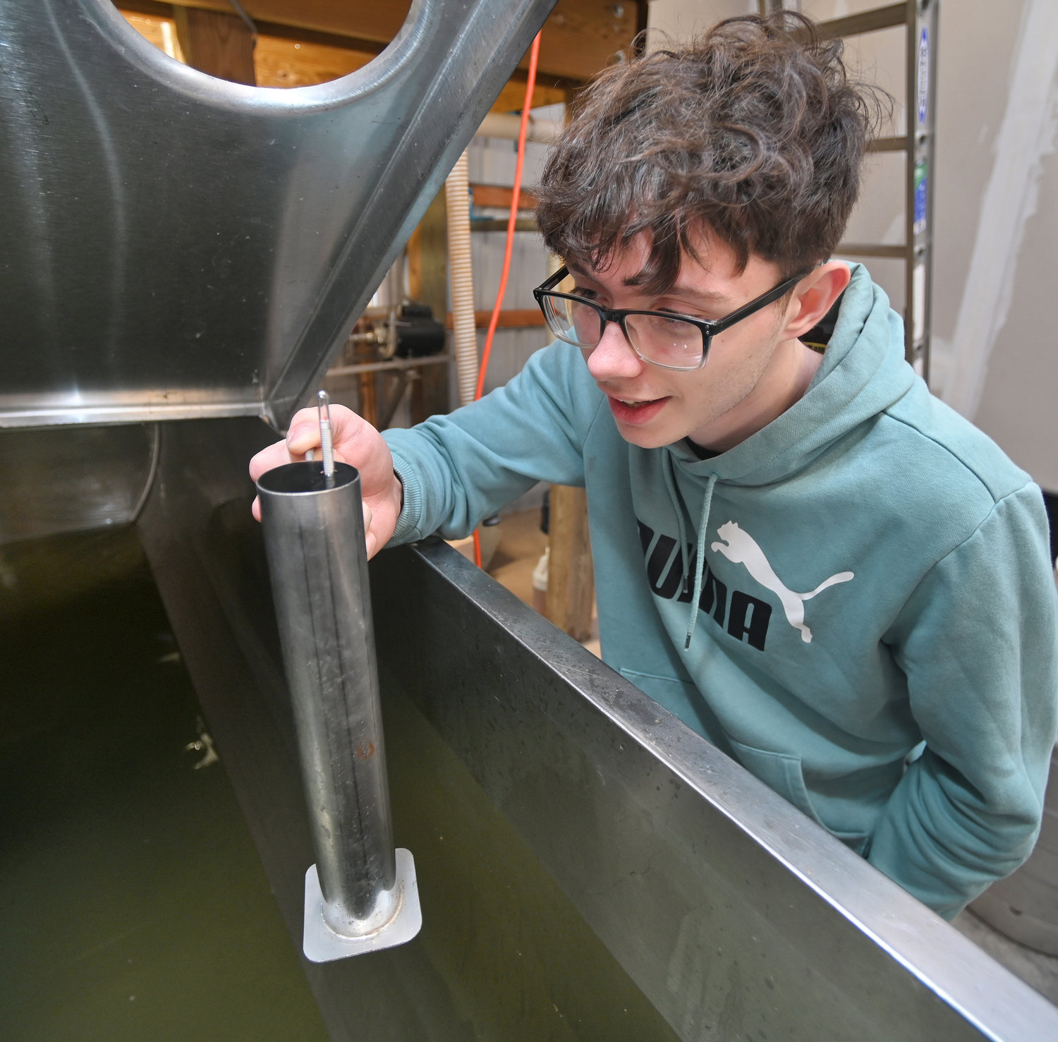 Hayden Dye, a 10th grader at Stockbridge Valley Central School, gets a hydrometer reading of the maple sap they have collected Wednesday, Feb. 15 in the sap house at the Munnsville school.