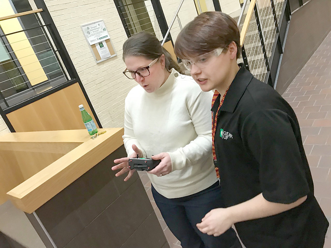 Rome Free Academy junior and Drone Soccer Club competitor Olivia Tyler, right, teaches Rome City School District Board of Education member Cassie Knutti how to play soccer with flying drones Monday, Feb. 13 on Mohawk Valley Community College's Rome campus.