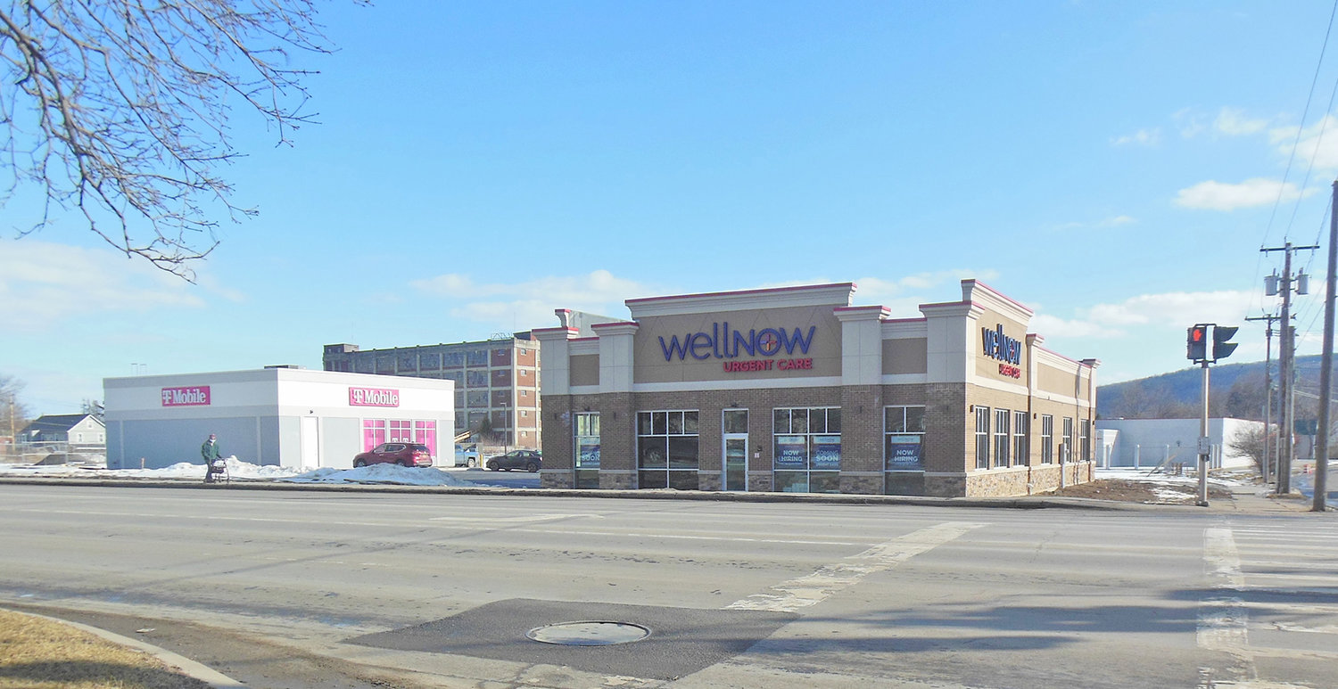 Two new business buildings have taken shape in a portion of the former Kmart parking lot at the corner of South Washington and State streets in Herkimer. T-Mobile is open for business and WellNow Urgent Care has had signs up indicating it is hiring and will open soon.