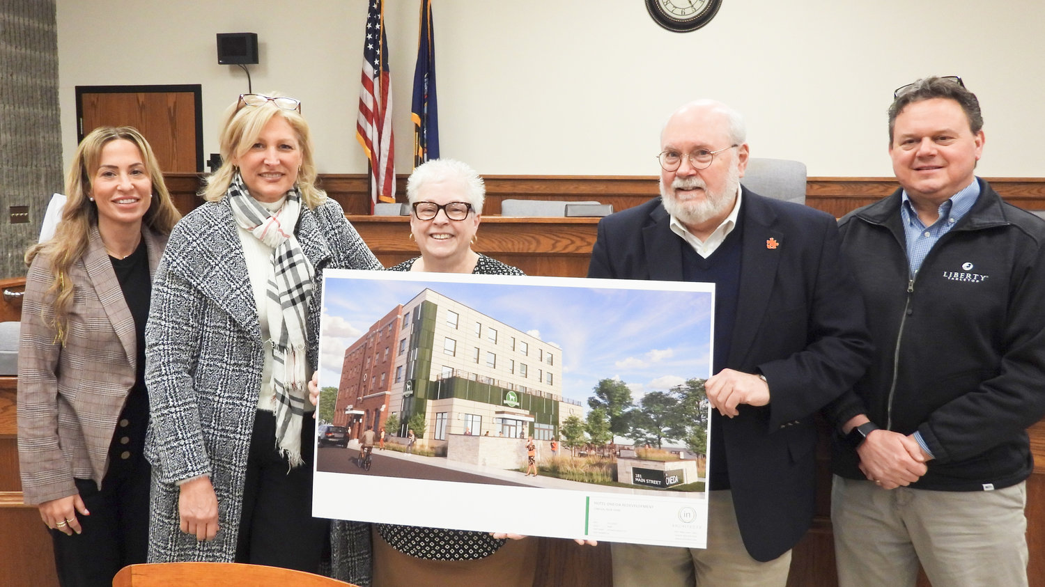 Members of Oneida city government and a member of the development team pose with a rendering showing what the Oneida Hotel will look like in 2024. Pictured: Supervisor Brandee DuBois, left, Mary Cavangh, Mayor Helen Acker, Managing Member Edward Riley, and Supervisor Matthew Roberts