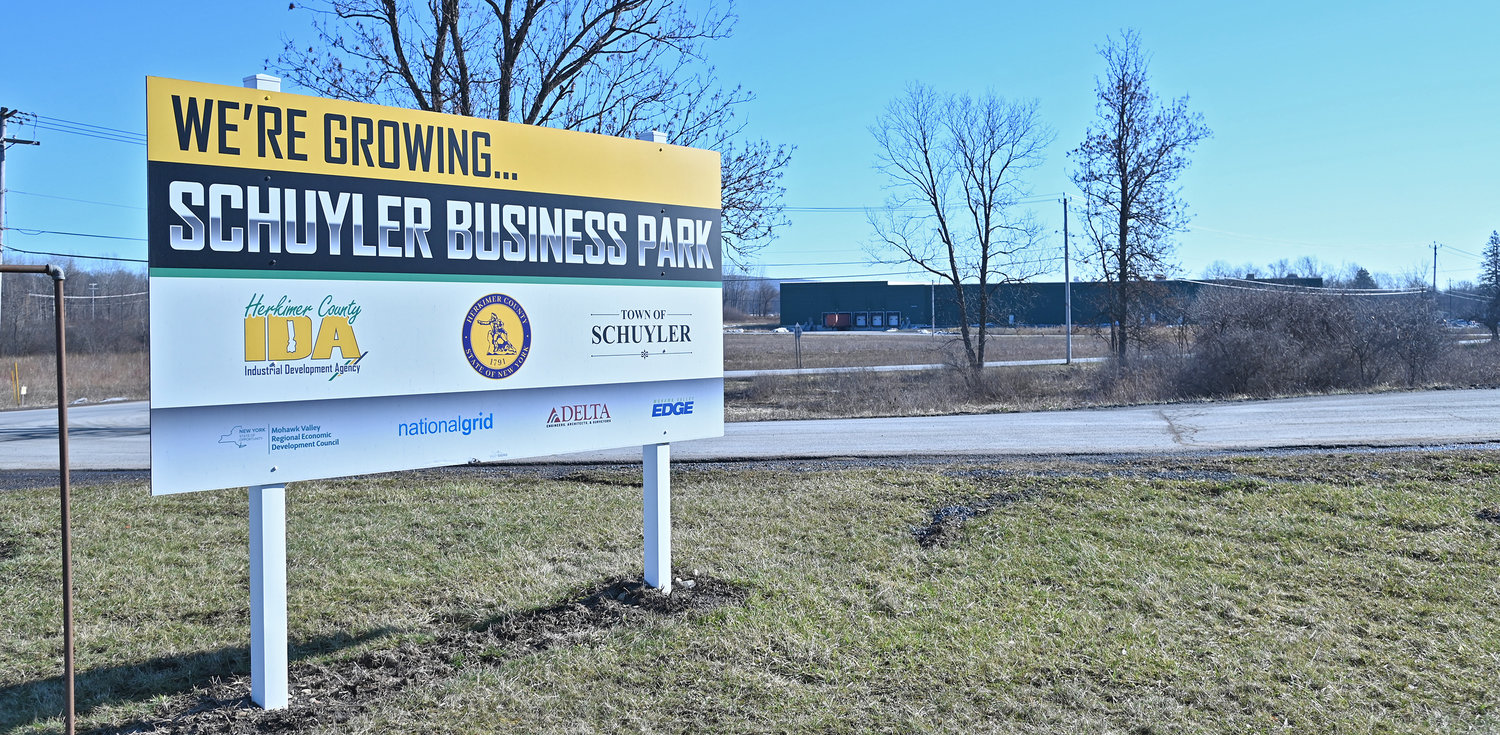 Sign off Route 5 with a building in the background of the Schuyler Business Park.