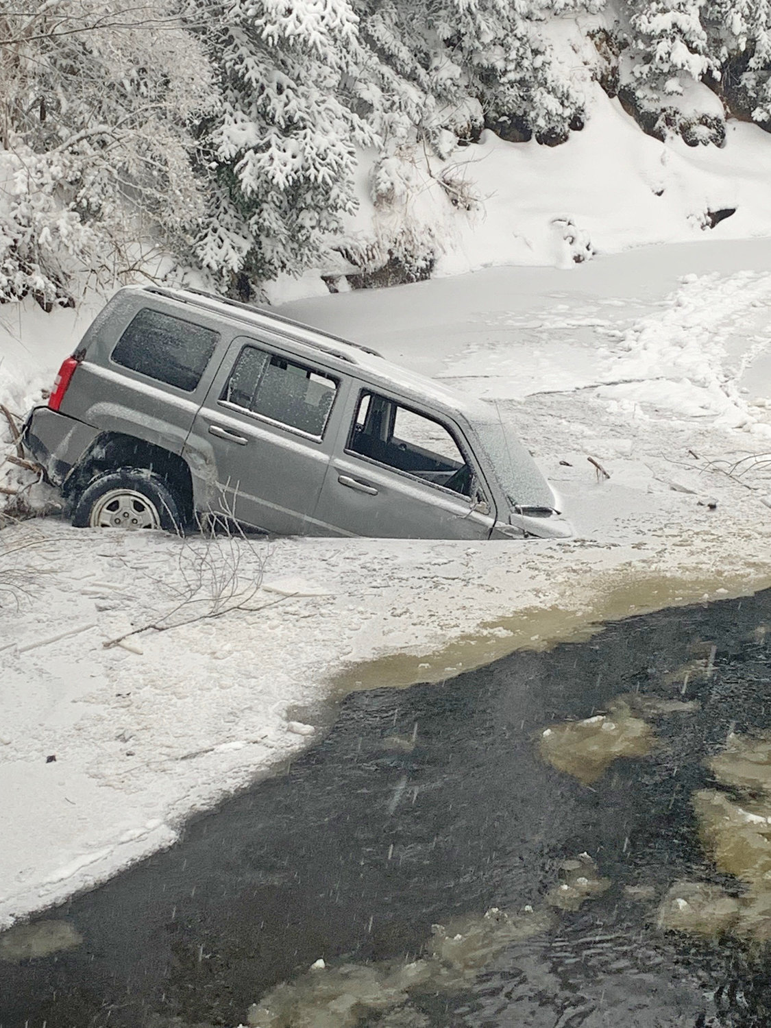 Three people were able to escape after this Jeep crashed into the Moose River in the Town of Webb at about 2 a.m. Sunday, according to the Webb Police Department.