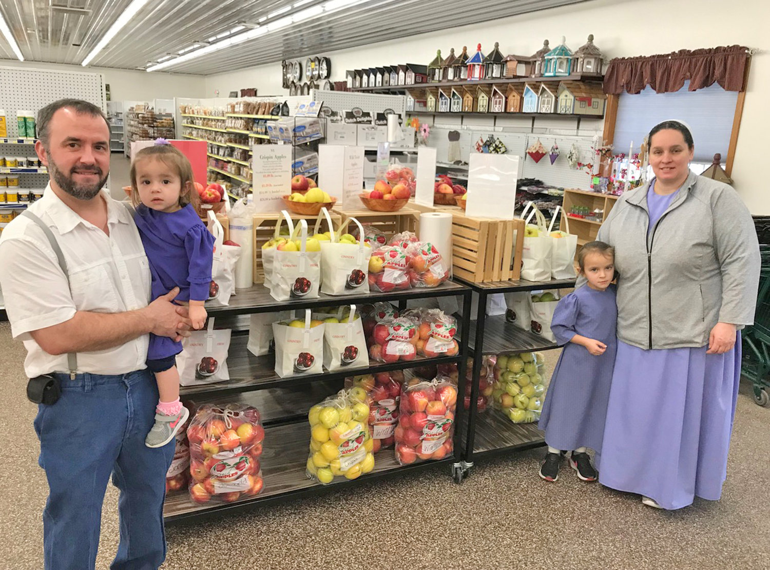 Olde Country Market owners Myron Stoltzfus and Regina Stoltzfus pose with daughters Lakeisha and Rainelle Monday, Jan. 30 at their Vernon store.