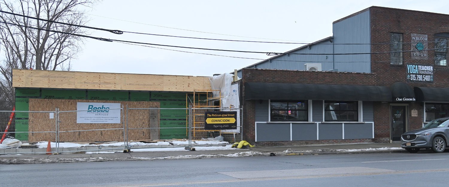 The exterior of One Genny, located at 1 Genesee St. in New Hartford, with construction underway on The Patio on 42nd Street, is set to open this spring.