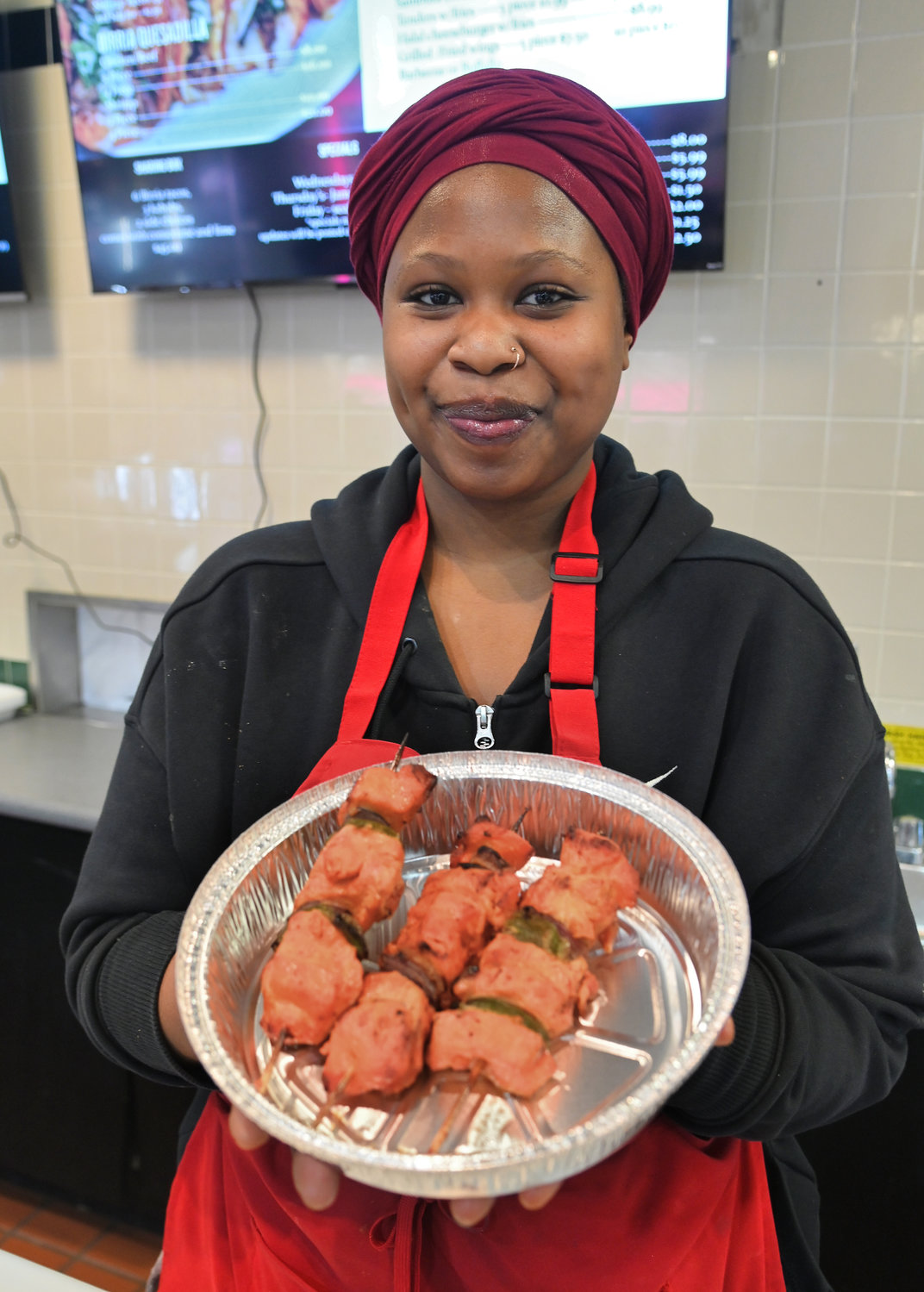 Luley Jibril of Jibril’s Kitchen at Sangertown Square with chicken kabobs ­­­— a specialty of the restaurant.
