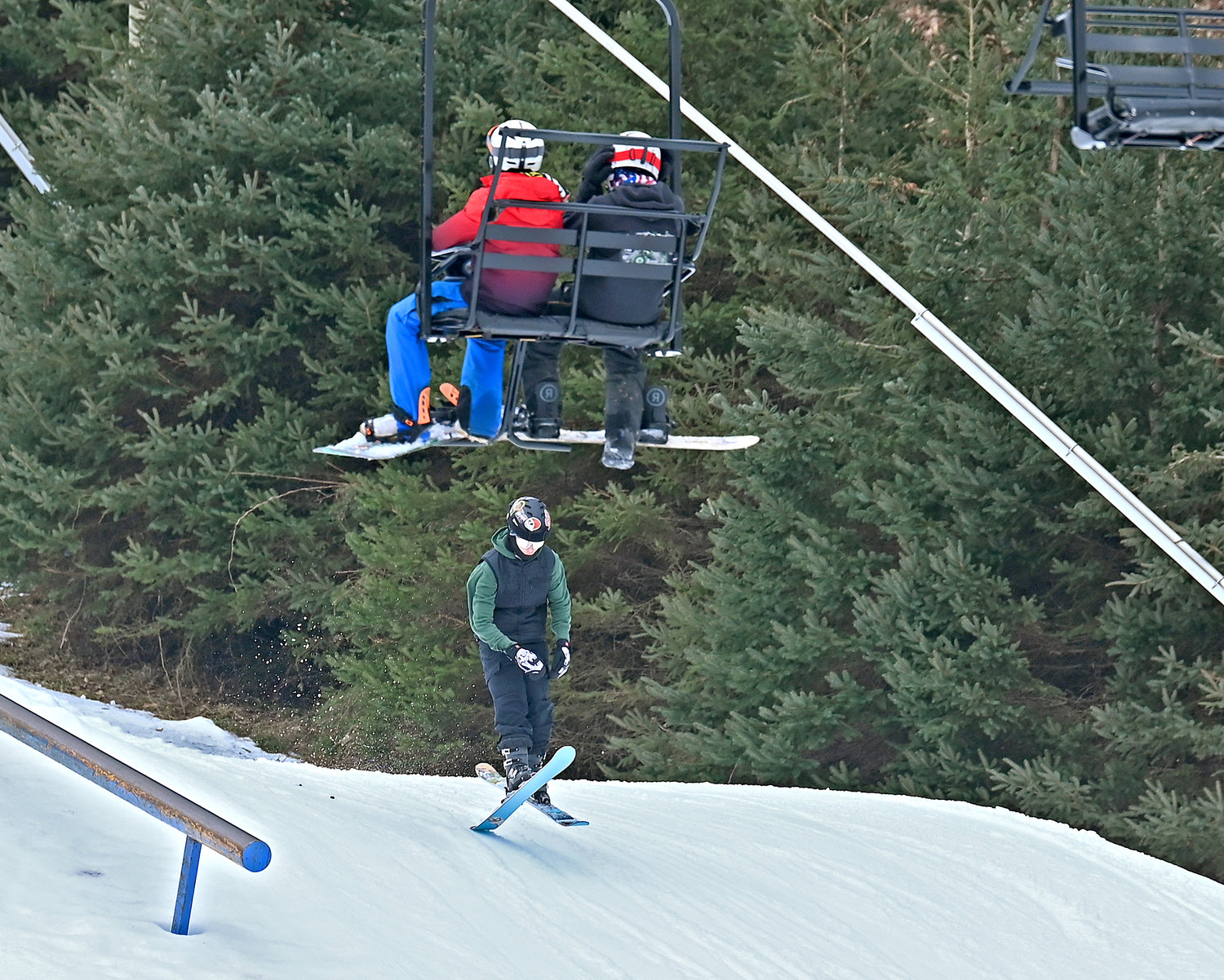 Skier at Woods Valley Ski Center with other skiers heading up the hill Monday, Feb. 20.