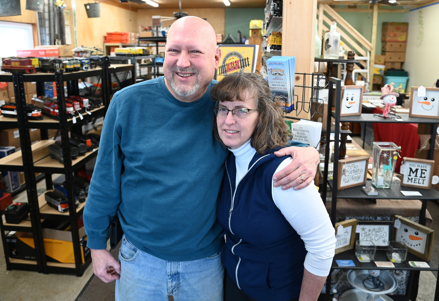 Whistle Post Antiques and Whistle Post Creations owners John and Brenda Thorna pose between their shops Friday, Feb. 3 in Bouckville.